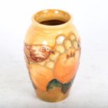 A Moorcroft tube-lined vase with bird and fruit decoration, 10cm
