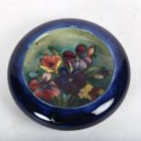 A Moorcroft blue dish with tube-lined spray of flowers, 11cm across, boxed