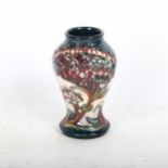 A tube-lined Moorcroft vase with stylised decoration, 9.5cm, boxed