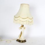 A table lamp supported by a ceramic gilded figure, with ornate shade, height 60cm overall