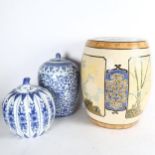 A ceramic Oriental garden seat, 42cm, and 2 blue and white jars and covers