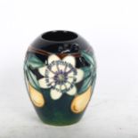 A Moorcroft vase with tube-lined passion flower design, 9cm, boxed