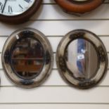 A pair of composition framed oval mirrors with embossed decoration, 34cm