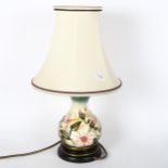 A small Moorcroft tube-lined table lamp with floral decoration, and shade, height 37cm