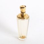 A faceted glass scent bottle, with an engraved unmarked yellow metal mount