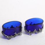 Pair of Elizabeth II .925 silver-mounted salts, with blue glass liners