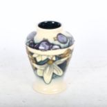 A Moorcroft tube-lined Whinberry design vase, 9cm, boxed