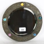 An Arts & Crafts circular pewter wall mirror, with polychrome Ruskin enamel bosses, overall diameter