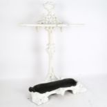 A cast-iron umbrella stand, painted white, tray is painted black, height 74cm, width 45cm