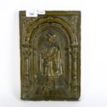 An earthenware green glazed plaque, depicting a figure in an archway, height 31cm