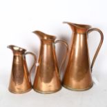 A graduated set of 3 copper jugs, marked J.S.&S England, tallest 33cm
