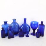 A group of Bristol blue bottles, and a goblet, tallest 18cm