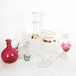 Miniature crystal figures, gilt decorated crystal decanter and matching water jug, a cranberry glass