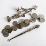 A Continental coin bracelet, a silver charm bracelet, and silver-handled button hook
