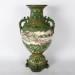 A large Japanese 2-handled vase, with allover green glaze applied decoration with central village
