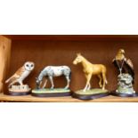 A group of 4 Royal Doulton animals and birds, including a Golden eagle, on separate plinths, boxed