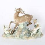 A Lladro tableau depicting 2 hounds taking down a gazelle, height 29cm