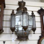A Moroccan pressed metal glass-panelled wall light with mirrored back, height 70cm (1 glass panel