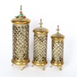 A set of 3 Eastern design pierced brass candle lanterns, tallest 31cm
