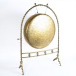 An early 20th century brass gong on stand, height 74cm