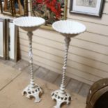 Pair of white painted cast-iron garden stands, on tripod plinths, 82cm