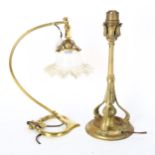 A stylised Art Nouveau desk lamp with vaseline frilled shade, and an Arts and Crafts brass single