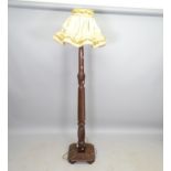 A mahogany turned wood standard lamp, on platform base, height to bayonet fitting 163cm