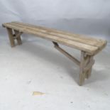 A Vintage pine bench on folding legs, L182cm x 44cm x 28cm