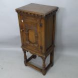 An Antique Ipswich oak design pot cupboard, with single panelled door and carved decoration, 42cm