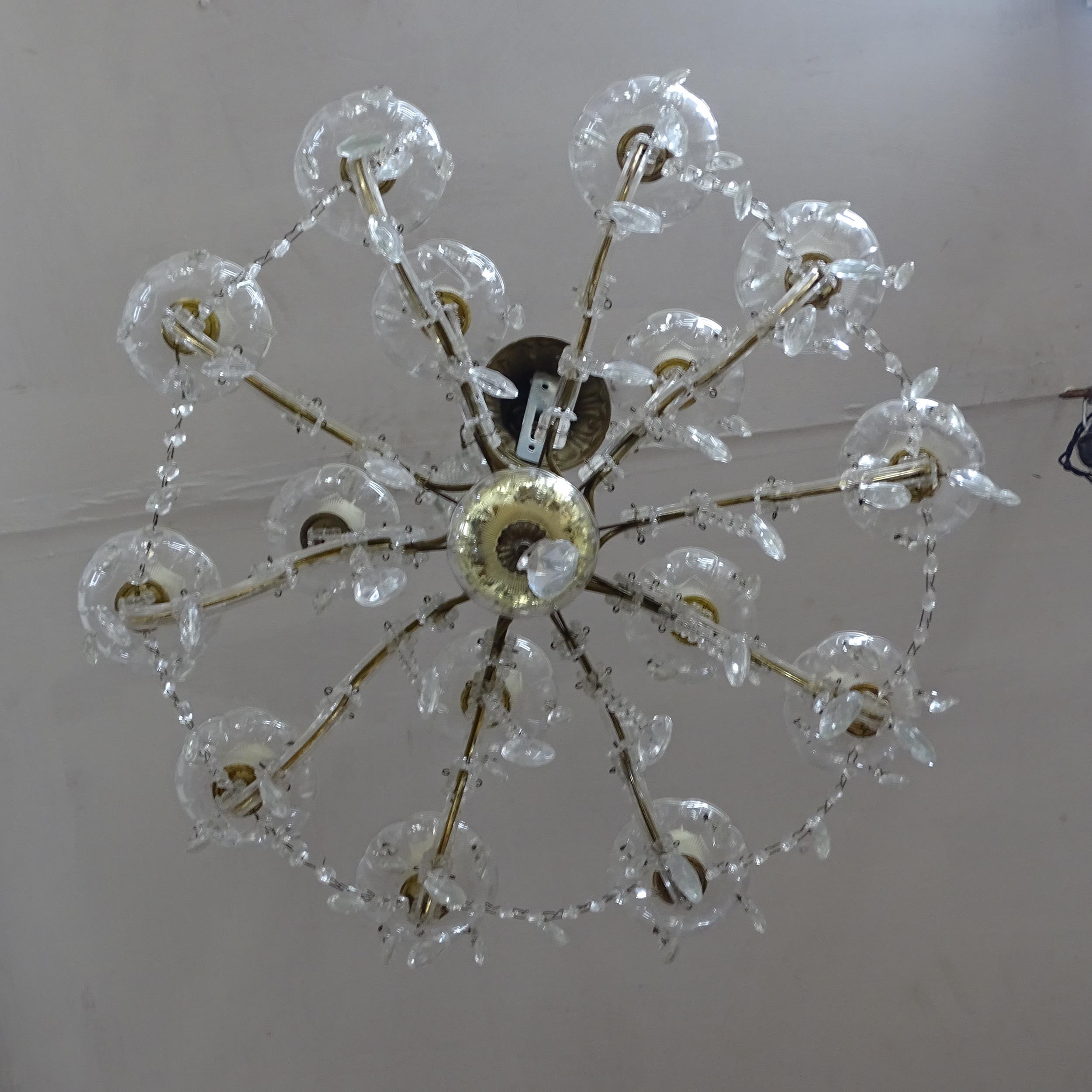 A brass and glass 10-branch chandelier, with lustre drops