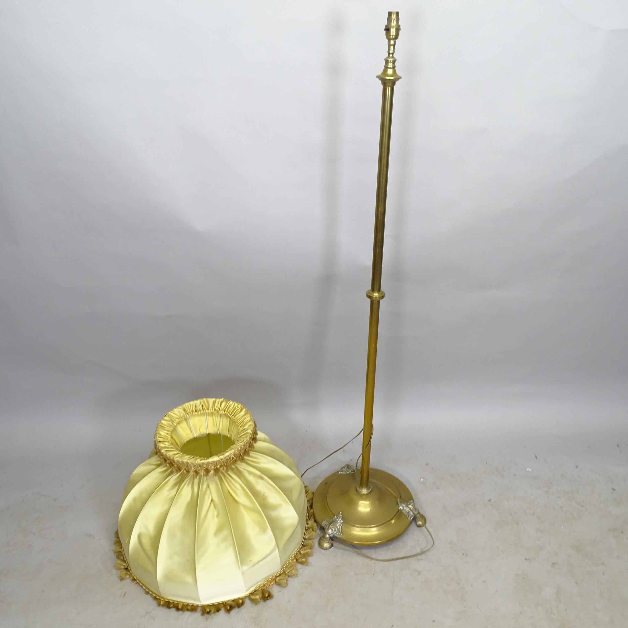 A brass standard lamp on platform base, height to bayonet 140cm