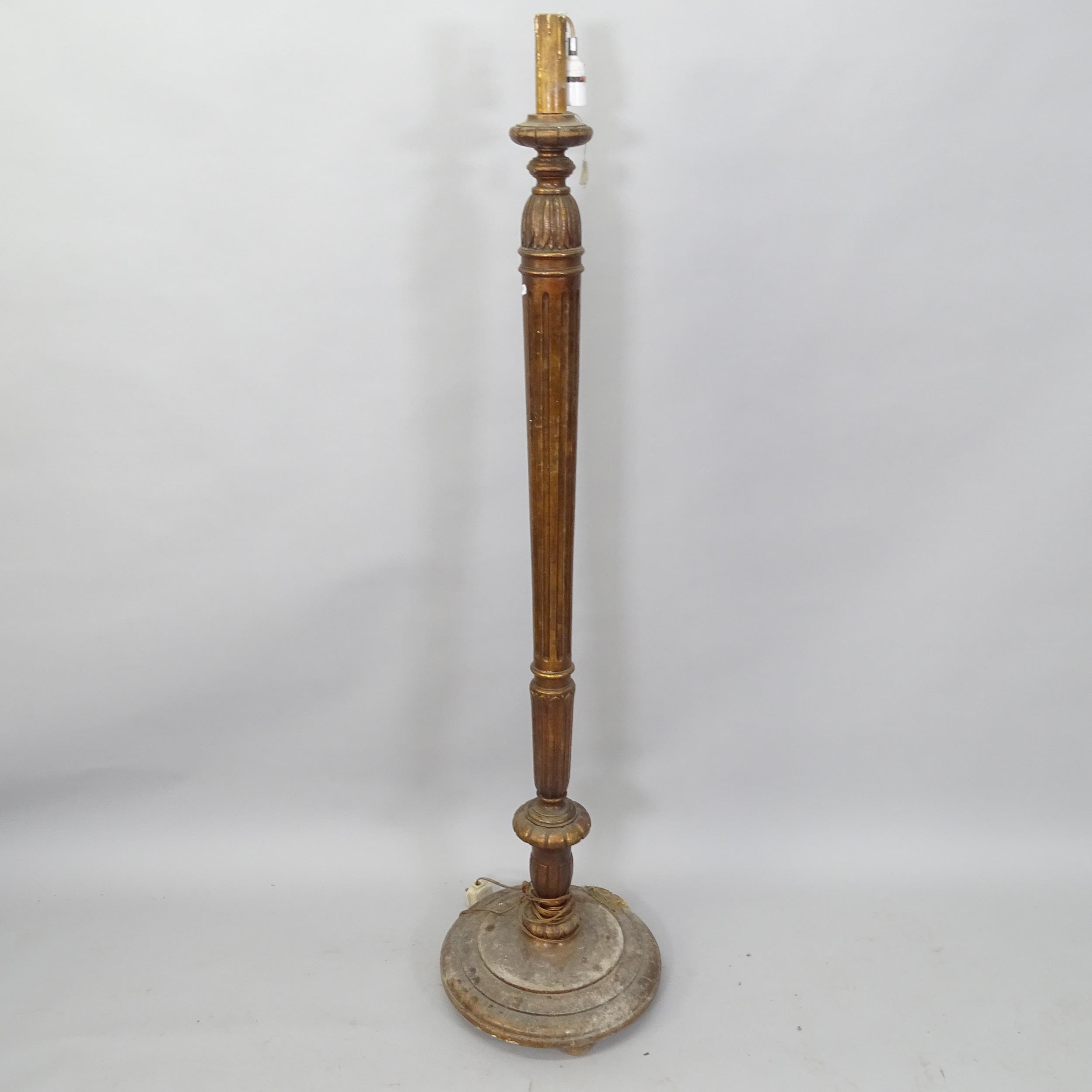 An Antique mahogany standard lamp, with fluted column and carved decoration, H150cm