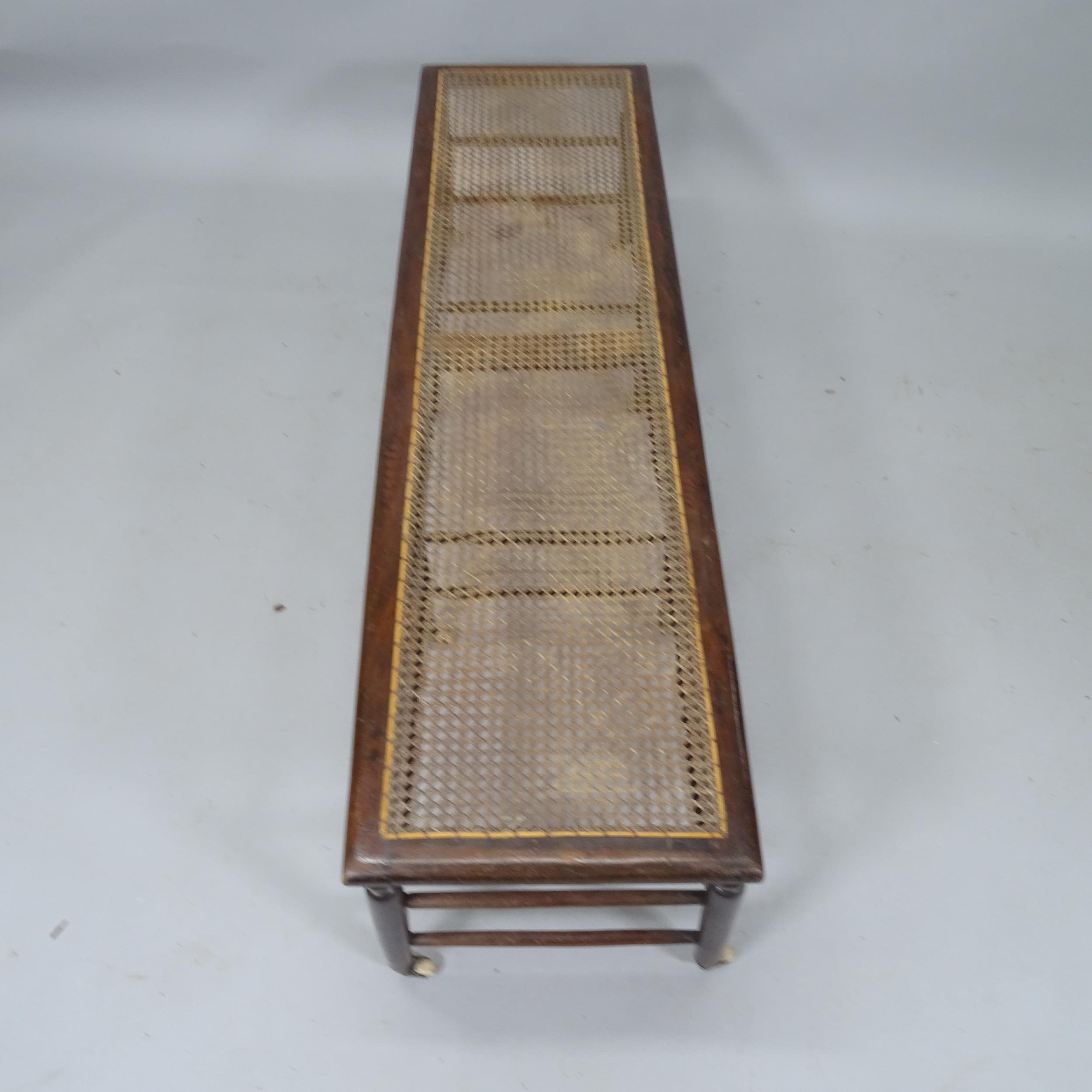 A Victorian window seat with caned panel, turned spindles and original casters, 137cm x 39cm x 39cm - Image 2 of 2