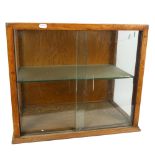 An early 20th century oak-framed table-top shop display cabinet, with single glazed shelf, width