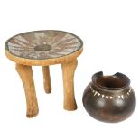 An Ashanti stool with inset beadwork decorated seat, height 29cm, and an African terracotta