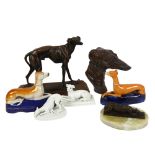 A bronze resting Greyhound on onyx plinth, 14cm overall, a Staffordshire Greyhound desk stand, and
