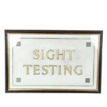 A gilded glass Optician's Testing sign, framed, overall 53cm x 80cm