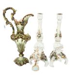 A pair of candlesticks with applied flowers, 33cm, and a ewer