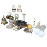 A large quantity of light fittings and lamps, including various oil lamps, a cloisonne ceramic lamp,