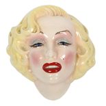 An American Art Pottery painted wall mask of Marilyn Monroe, height 23cm