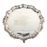 A George V silver salver of shaped form, on cast feet, with presentation inscription (presented to