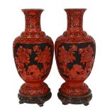 A large pair of Chinese cinnabar vases on carved wood stands, vase height 38cm, overall height