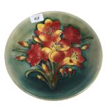 A Moorcroft tube-lined Adriatic Lily design plate, signed to the reverse, diameter 26cm Plate has