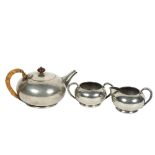 LIBERTY & CO - Tudric pewter teapot, milk jug and sugar pot, serial markings to the underside of the