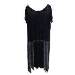 A 1920s style black flapper dress, with intricate beading decoration, no size label