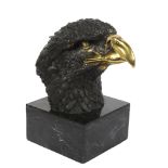 After Archibald Thorburn, a parcel-gilt bronze eagle head sculpture, on black marble base, unsigned,