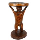 An African hardwood Tribal stool, with carved seat and figural support, height 53cm, width 30cm Good