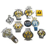 A collection of car badges, including AA, Jamaica AA, RAC, and Rover