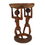 An African hardwood Tribal fertility stool, with painted top and double-figural supports, height