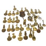 A quantity of brass tea caddies or collector's spoons, including an Antique doorbell